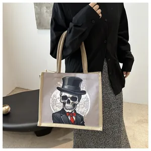 Detail of canvas tote bag featuring skull gentleman print with weave texture trim