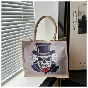 Artistic close-up of a canvas tote bag with a skull print by a sunlit window