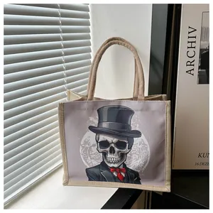 Jute tote bag with gentleman skull print placed on a window sill in natural light