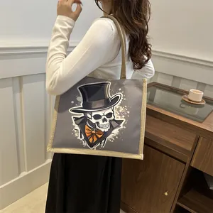Deep grey canvas tote bag with skull illustration and rustic jute handles