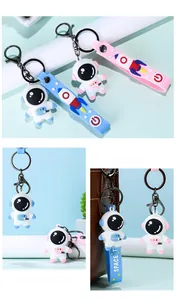 Detailed view of cute 3D cartoon astronaut keychains in blue and pink