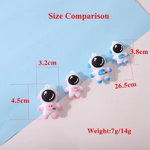 Cute cartoon astronaut keychain charms in pink and blue colors for backpacks and bags