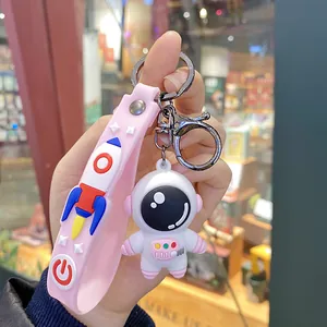 Cute cartoon astronaut keychain with pink rocket silicone strap accessory for bags