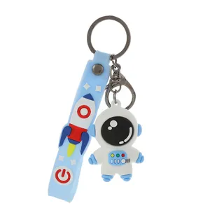 Cute white cartoon astronaut keychain with blue silicone rocket strap for backpack charm