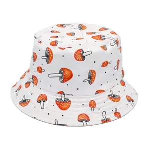 Detailed view of a white bucket hat with vibrant orange mushroom and black dot print