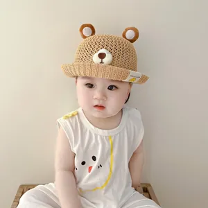 Infant model wearing a breathable straw sun hat with cute bear ears design