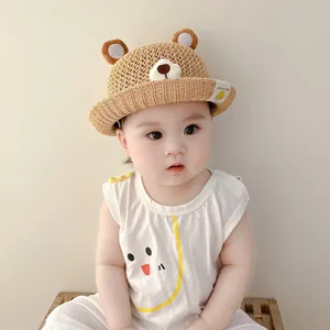 Close-up of baby wearing a breathable straw bucket hat with 3D bear ears design