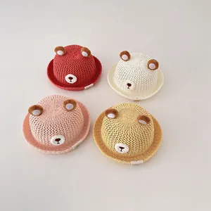 Group of four breathable straw sun hats for babies featuring cute 3D bear ear designs