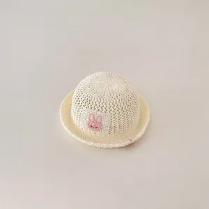 Minimalist breathable baby straw sun hat with cute pink crochet bunny patch detail
