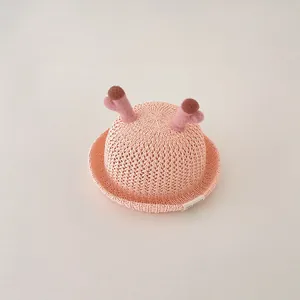 Cute pink baby sun hat featuring plush deer antlers and breathable straw texture