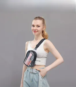 Clear PVC crossbody bag with adjustable black strap showing compact internal storage capacity