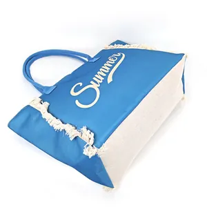 Close-up of canvas tote bag with fringe edge and yellow Summer cursive print