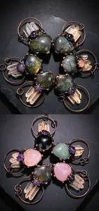 Detailed view of handmade copper wire-wrapped natural crystal pendants on fabric