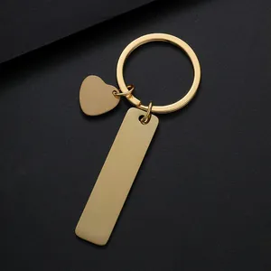 Polished gold stainless steel keychain featuring a heart charm and long rectangular pendant