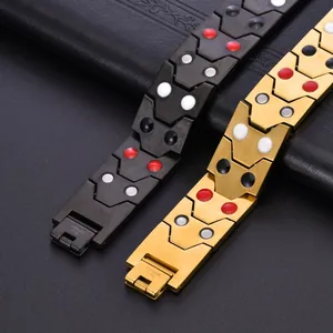 Close-up of magnetic stainless steel bracelets with V-shaped links and inner functional dots