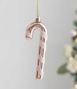 Detail of rose gold and white glitter candy cane ornament for Christmas decor