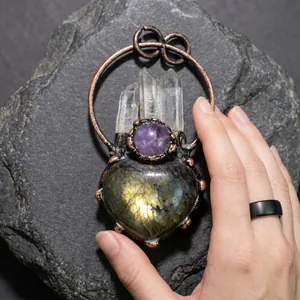 Detail of handcrafted copper pendant with amethyst and heart-shaped labradorite stones