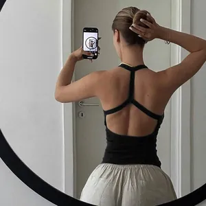 Detail view of women black ribbed tank top showing Y-back cutout and racerback design