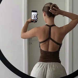 Detail of a brown backless ribbed tank top featuring slim racerback straps and hollow design