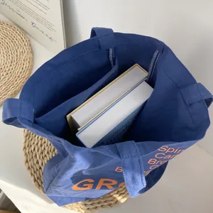 Spacious interior of blue canvas tote bag showing large capacity for books