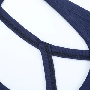 Close-up of blue ribbed fabric stitching and durable cross-strap seams on sport top