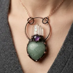 Macro detail of heart-shaped green stone pendant with amethyst and quartz crystal
