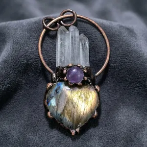 Detail of bronze heart labradorite pendant with amethyst bead and clear quartz points