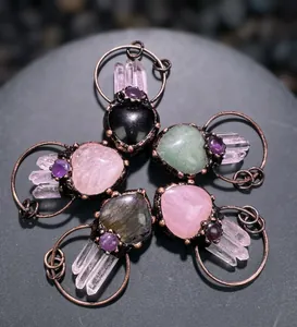 Detail view of five heart-shaped crystal pendants with bronze frames and white quartz