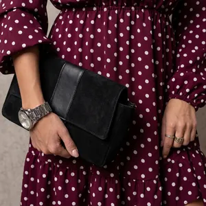 Detail of burgundy paisley V-neck dress with long flared sleeves and ruffled hem