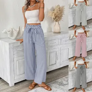 Detail of high waisted wide leg trousers with bow tie and vertical stripes in four colors