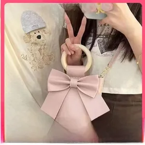 Pink bow-shaped DIY mini coin purse featuring a round resin handle and gold chain
