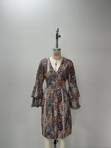 Detailed view of the deep V-neckline and multi-layered paisley bell sleeves on the dress