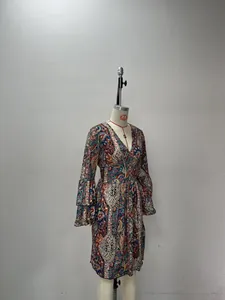 Detail of bohemian paisley print dress featuring layered ruffle flare sleeves and V-neckline