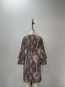 Detail of bohemian paisley print dress showing layered bell sleeves and elastic waist