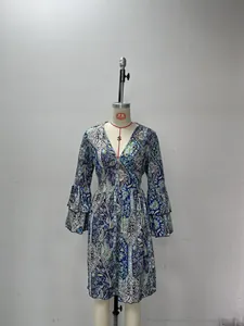 Detail of V-neckline and tiered bell sleeves on a navy paisley bohemian dress