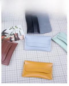 Detailed view of handmade leather card holders in five colors with fine white stitching
