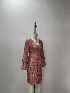 Detail of V-neckline and paisley print on a bohemian dress with bell sleeves