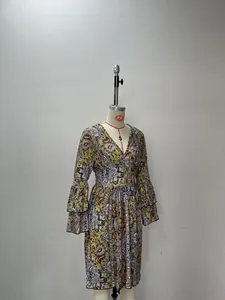 Detail of V-neckline and colorful paisley pattern on layered bell sleeve dress