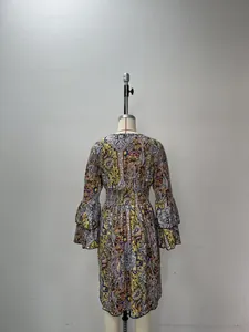 Detail of bohemian paisley print dress with elastic waist and layered bell sleeves