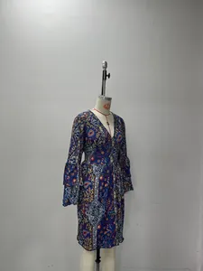 Detail of bohemian paisley print on royal blue V-neck dress with ruffled sleeves