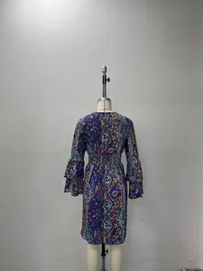 Detail of bohemian paisley dress featuring tiered ruffle sleeves and elastic waist