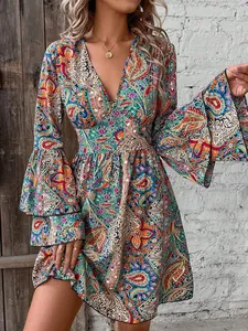 Detail of V-neckline and tiered bell sleeves on a bohemian paisley print dress