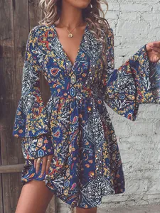 Close-up of vibrant paisley floral pattern on a deep V-neck dress with bell sleeves