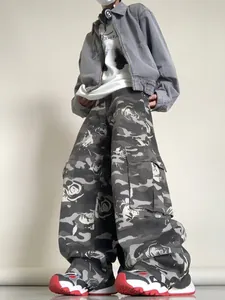 Detail of cargo pants with camouflage rose print and large utility side pockets