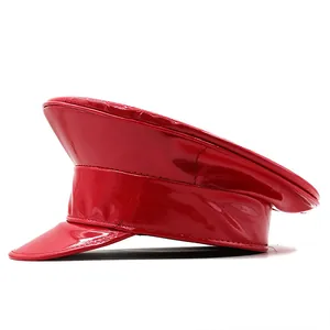 Detail of red glossy patent leather military cap showing fine stitching on a white background