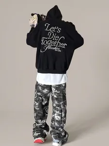 Close-up of pearl bead embroidery design on the back of a black street style hoodie