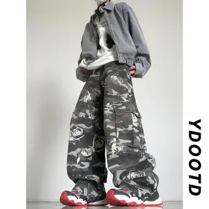 Detail of rose floral print on baggy camo cargo pants in street style outfit
