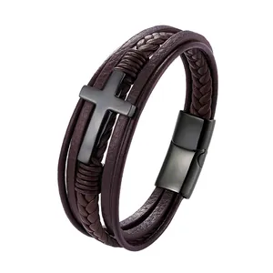 Detail view of multi-layer leather bracelet with matte black cross charm and magnetic clasp
