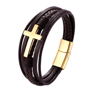Detail of dark brown braided leather multilayer bracelet with golden cross and magnetic clasp