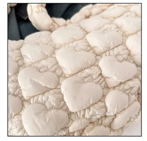Close-up of heart-shaped quilted pattern on ivory white ruched cloud bag material